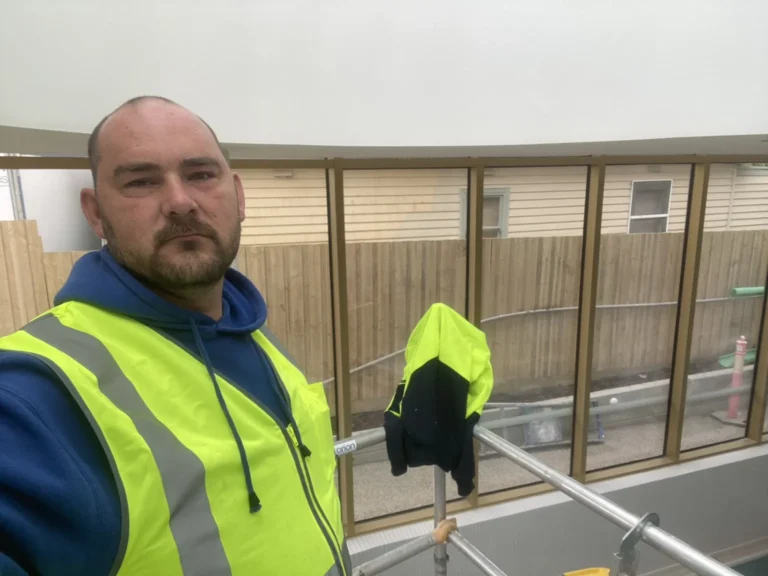 Barry from ACW Glazing wearing high visibility workwear at a glazing job