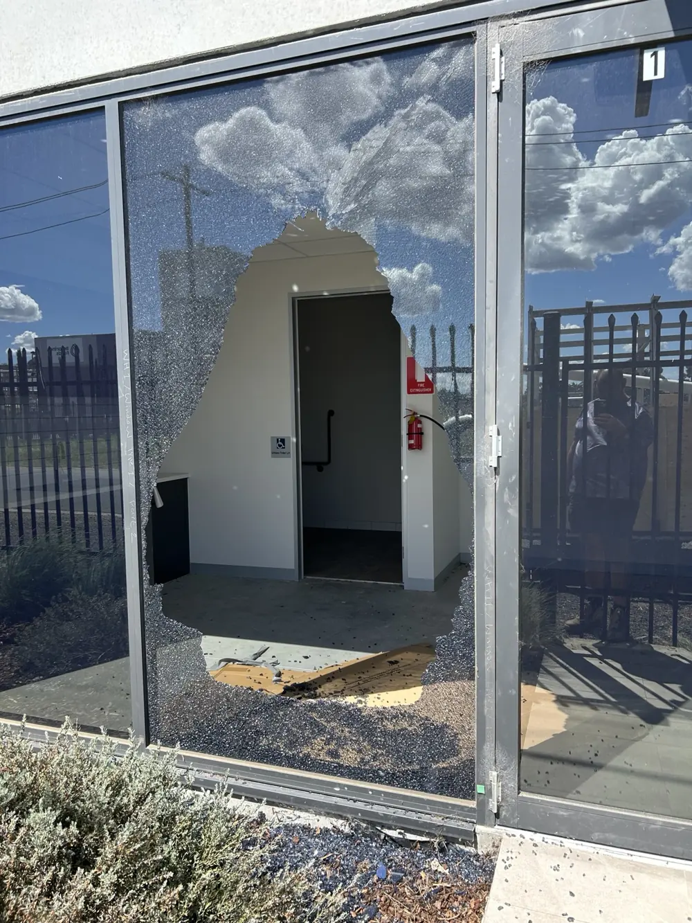Broken commercial window before emergency board-up by ACW Glazing & Maintenance