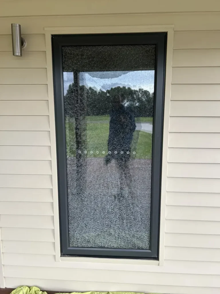 Shattered glass panel in a residential door before replacement